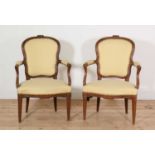 A pair of Transitional period walnut fauteuils,
