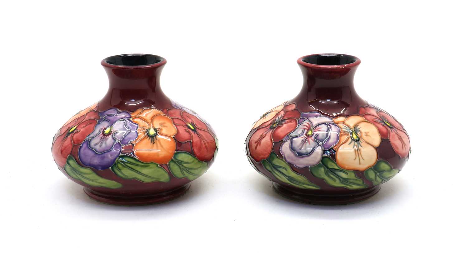 A pair of Moorcroft pottery ‘Pansy’ pattern vases,