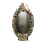 A German porcelain floral encrusted oval mirror,