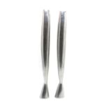 A pair of polished steel candlesticks,