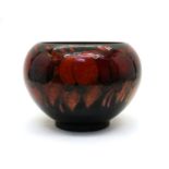 A William Moorcroft pottery Flambe ‘Wisteria’ pattern vase,