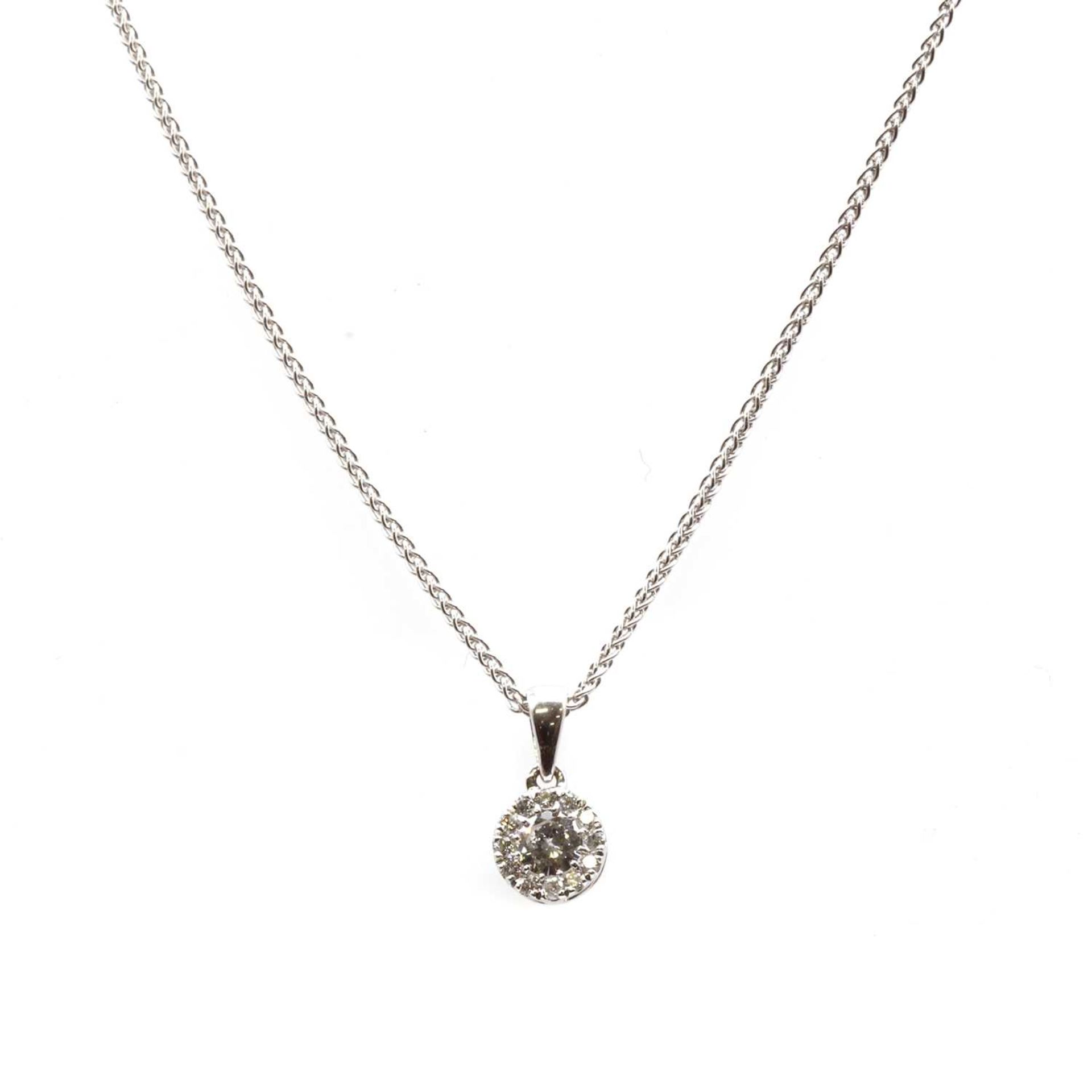 A white gold diamond cluster pendant,