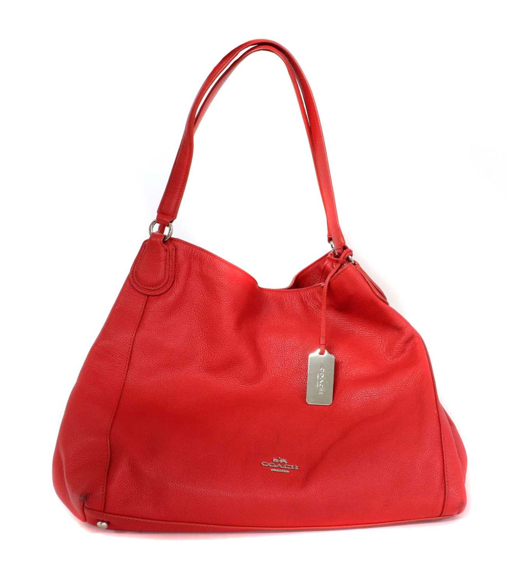 A Coach red leather Edie bag,