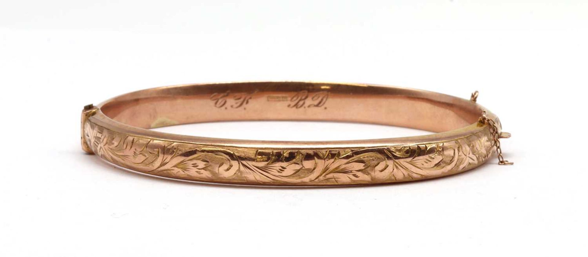 A 9ct gold hollow hinged bangle,