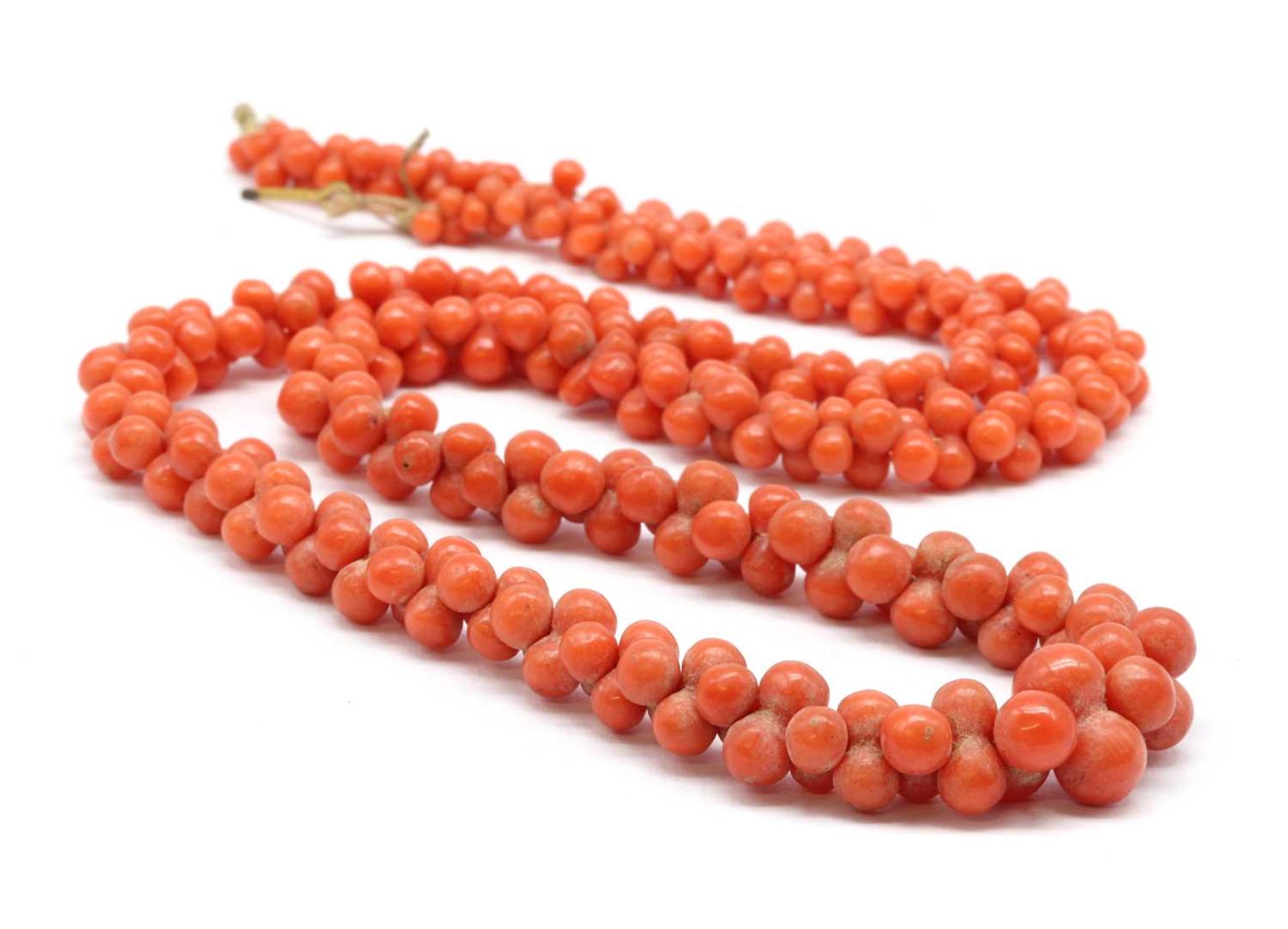 A graduated carved coral bead necklace,