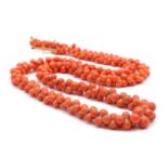 A graduated carved coral bead necklace,