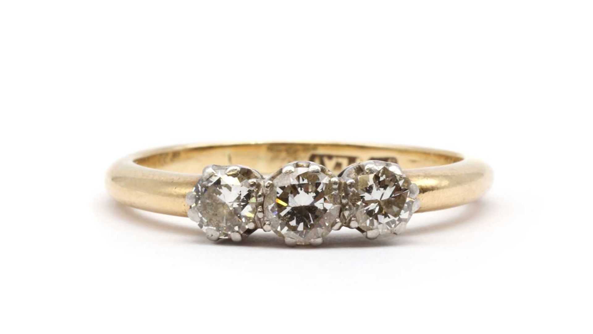 A gold three stone diamond ring,