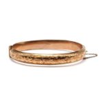 A 9ct gold hollow hinged bangle,