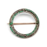 A gold emerald and diamond circle brooch,