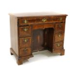 A George I and later kneehole walnut desk.