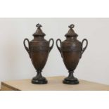 A pair of spelter urns and covers,