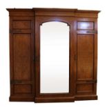 A late Victorian pollard oak breakfront triple wardrobe,