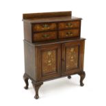 A low Victorian inlaid rosewood and grained cabinet,