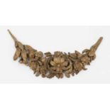 A carved fruiting and foliate overdoor swag,