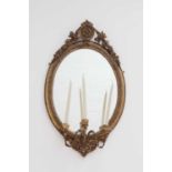 A three-light oval girandole mirror,