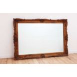 A large carved beech framed mirror,