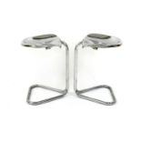 A pair of chromed tractor seat stools,