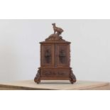 A Black Forest carved wooden table cabinet,