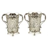 A pair of pierced Dutch silver glass holders