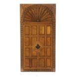 A carved oak and panelled door,