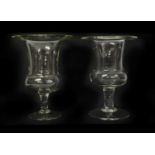 A set of three glass urns,