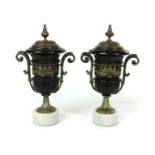 A pair of black slate, marble and brass urns,