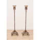 A pair of wrought iron and pottery candlesticks,