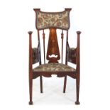 An Art Nouveau mahogany and inlaid armchair,