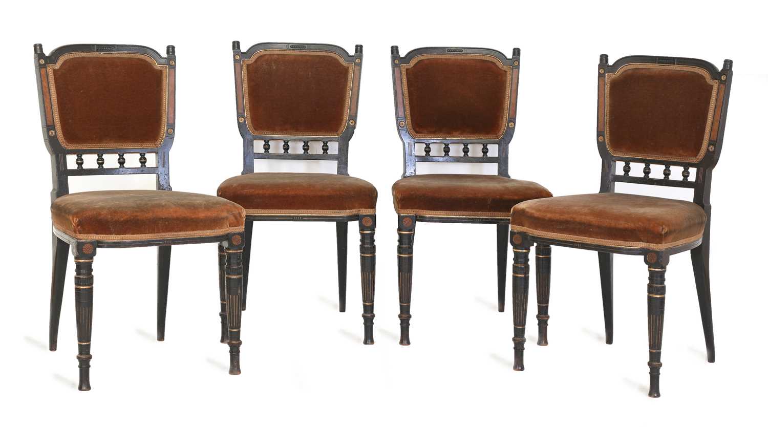 A set of four Aesthetic ebonised chairs,