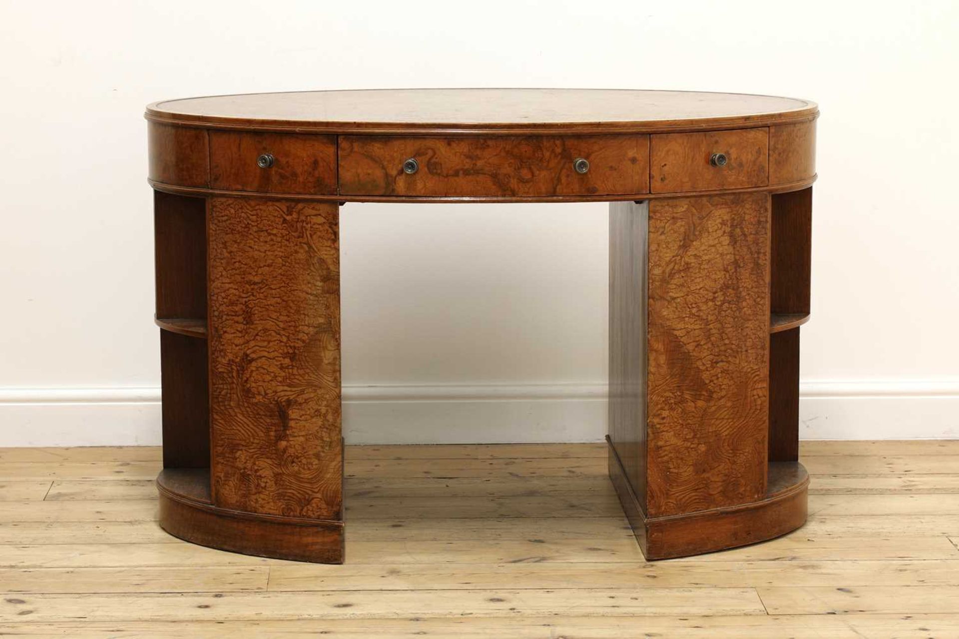 An Art Deco oval burr elm and walnut desk,