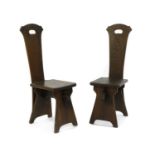 A pair of American Arts and Crafts oak hall chairs,