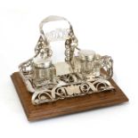 A silver and oak-mounted desk stand,