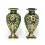 A pair of James Macintyre & Co. pottery Florian Ware vases,