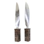 A pair of chrome aeroplane propeller blades,