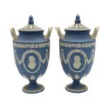 A pair of Wedgewood Jasperware twin-handled vases and covers,