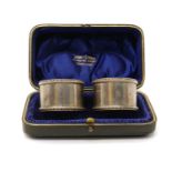 A cased pair of late Victorian silver napkin rings,