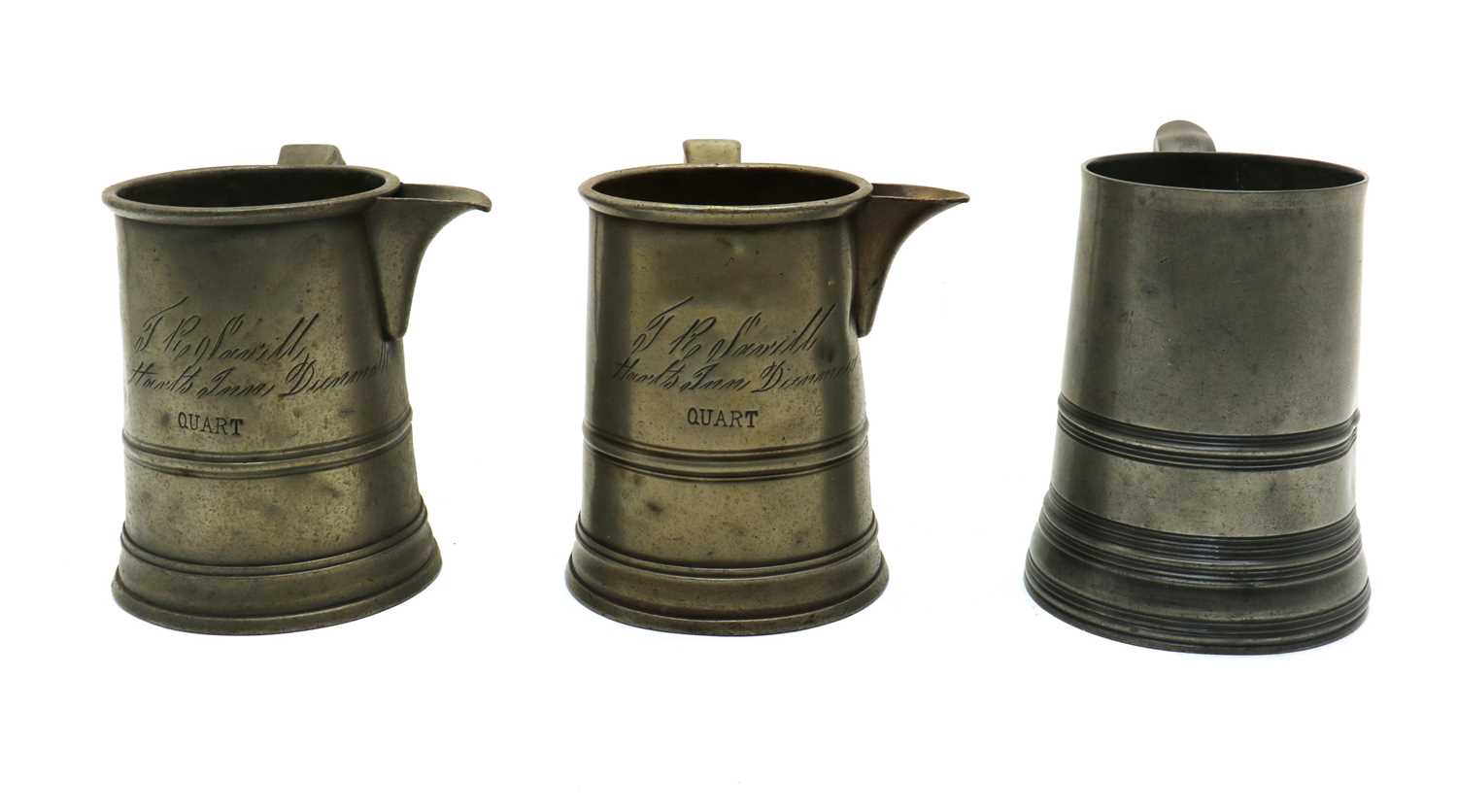 A group of three 19th century pewter quart mugs