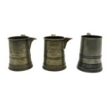 A group of three 19th century pewter quart mugs