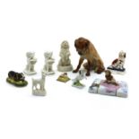 A collection of pottery and porcelain figures of dogs,