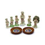 A group of six porcelain putti figures,