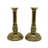 A pair of sectional brass candlesticks,