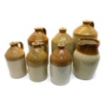 A collection of seven stoneware flagons,