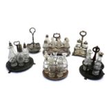 A collection of three silver plated cruet stands