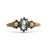 A gold blue zircon and split pearl ring,