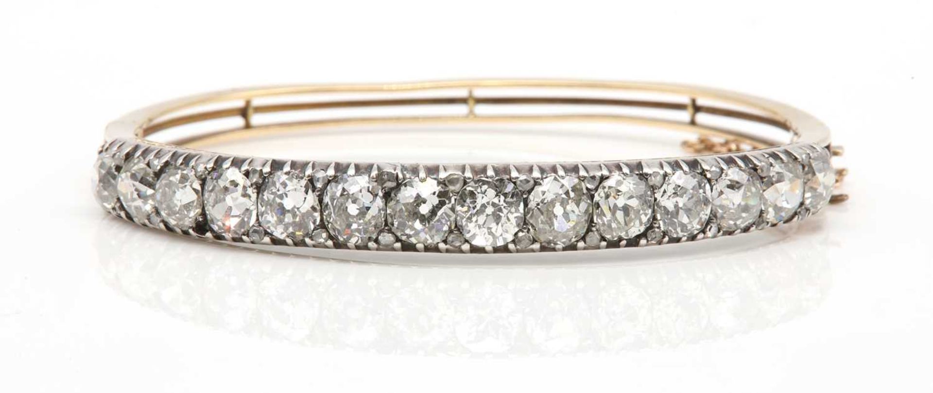 A late Victorian diamond set hinged bangle,