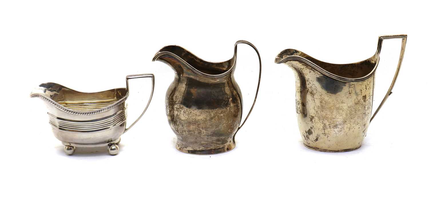 A group of three silver cream jugs