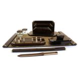 An Art Deco Macassar and ivory mounted seven piece desk set,