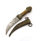 A small Middle Eastern brass dagger in scabbard