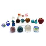 A collection of glass sixteen glass paperweights,