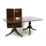 A George III style mahogany twin pedestal dining table,